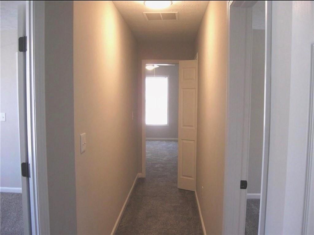 2225 Blue Ridge Lane Conyers, GA 30012 - Photo 19 of 40 a view of a hallway with a wooden door