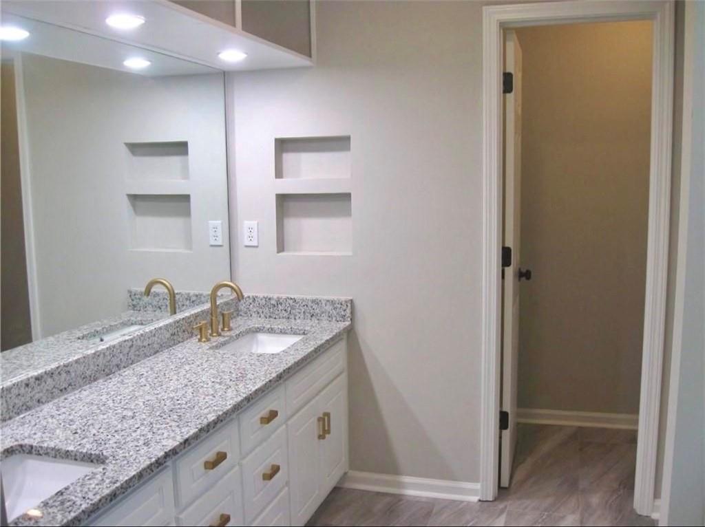 2225 Blue Ridge Lane Conyers, GA 30012 - Photo 26 of 40 a bathroom with a granite countertop sink and a mirror