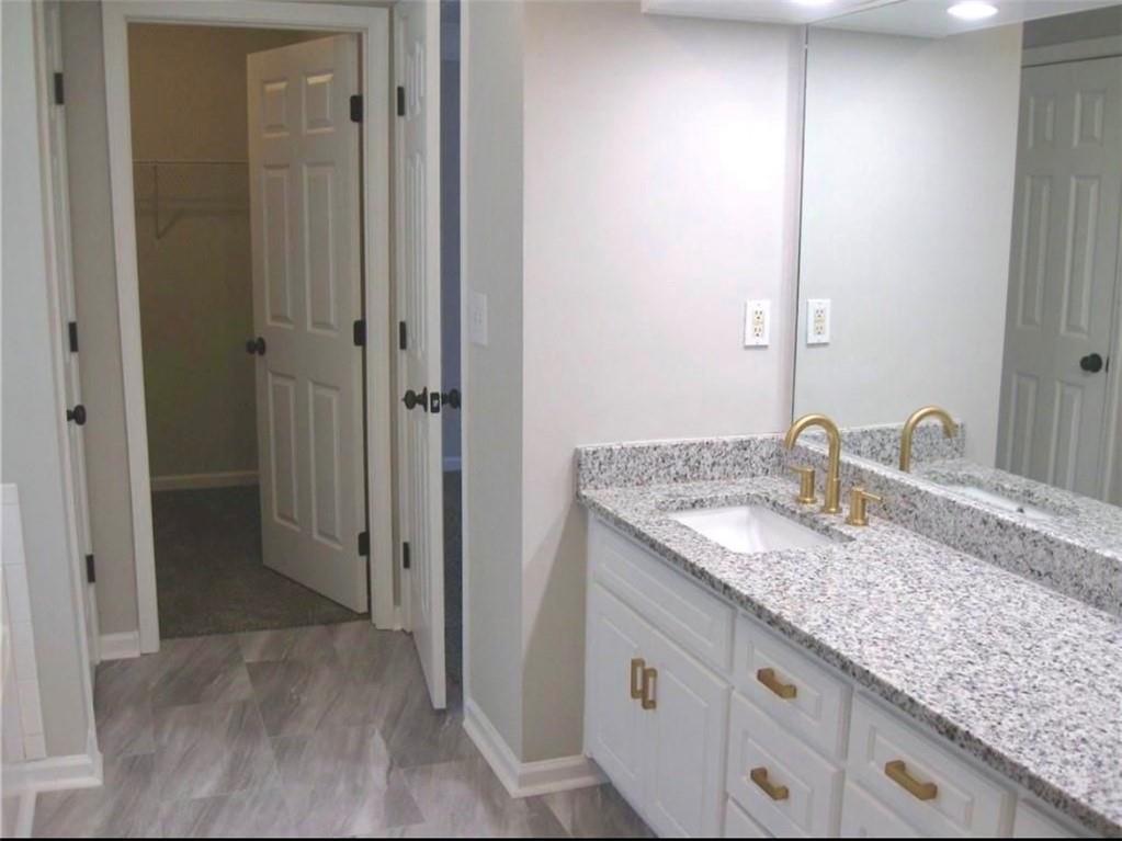 2225 Blue Ridge Lane Conyers, GA 30012 - Photo 28 of 40 a bathroom with a granite countertop sink and a mirror