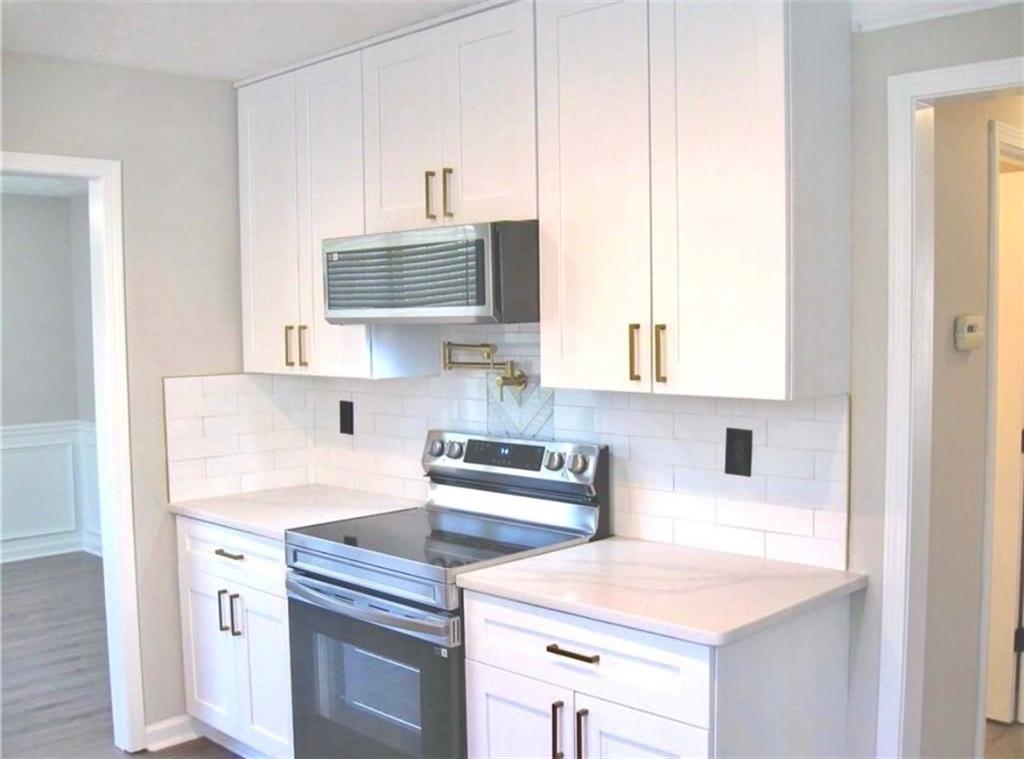 2225 Blue Ridge Lane Conyers, GA 30012 - Photo 6 of 40 a kitchen with a sink stove and cabinets