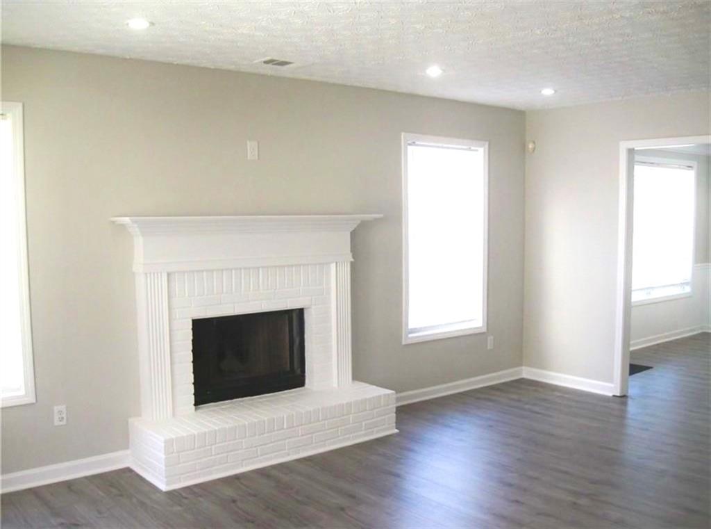 2225 Blue Ridge Lane Conyers, GA 30012 - Photo 10 of 40 a living room with a fireplace and wooden floor