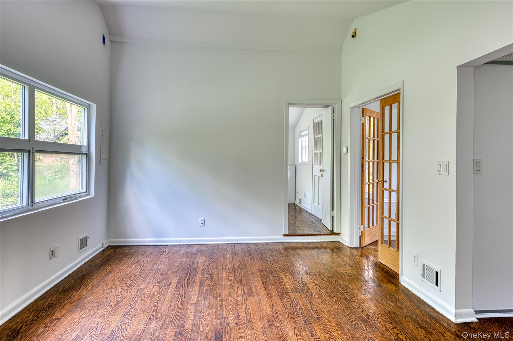 61 Indian Brook Road Garrison, NY 10524 - Photo 22 of 23 an empty room with wooden floor and windows