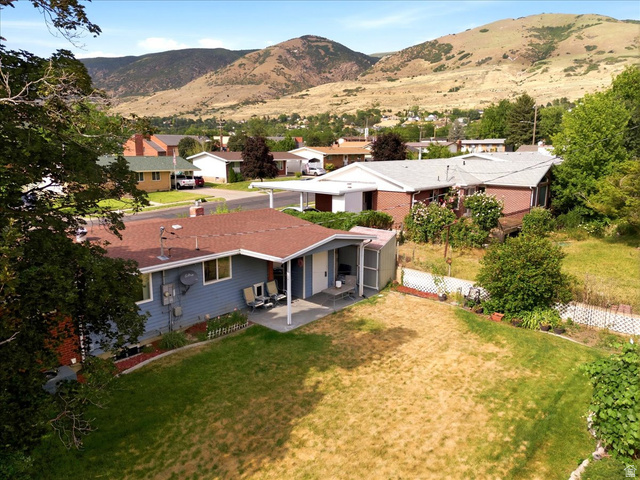 272 East 1400th Street North Bountiful, UT 84010 - Photo 34 of 38 Sweet (not too large, but just right) backyard area with a covered patio, garden beds, and mountain scenery
