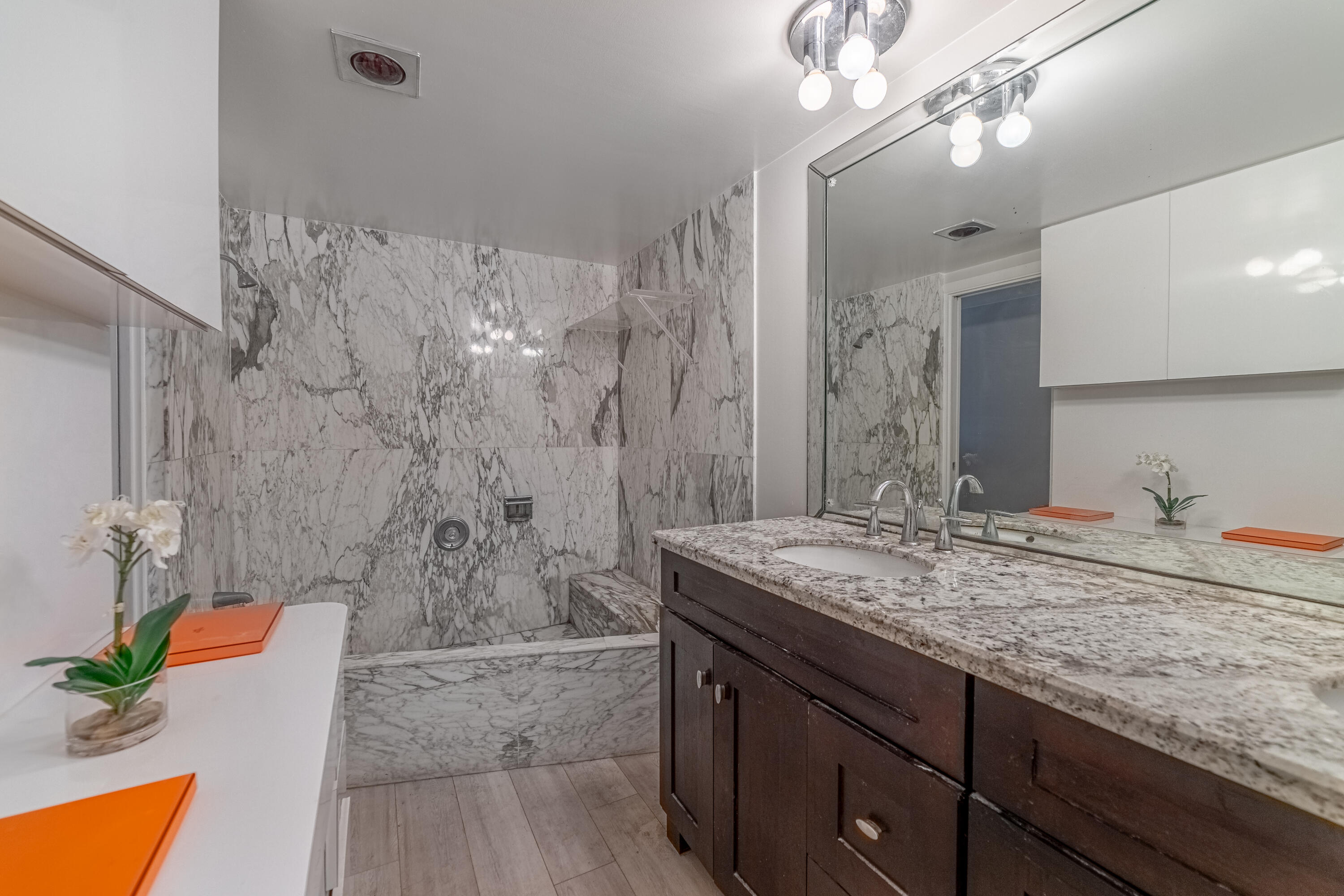 3475 South Ocean Boulevard, Unit 201 Palm Beach, FL 33480 - Photo 11 of 28 a bathroom with a granite countertop sink a mirror and a shower