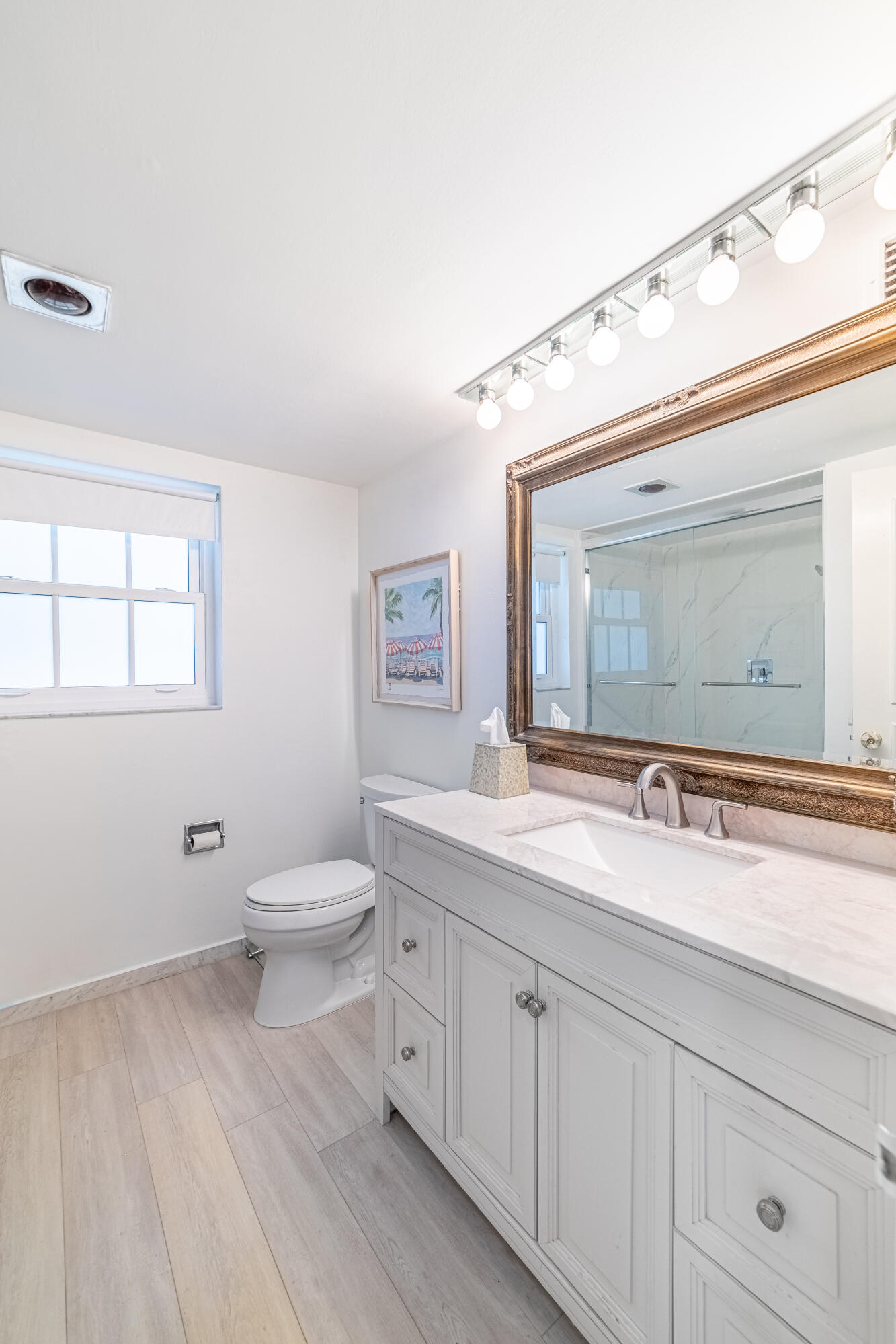 3475 South Ocean Boulevard, Unit 201 Palm Beach, FL 33480 - Photo 13 of 28 a bathroom with a toilet a sink and mirror