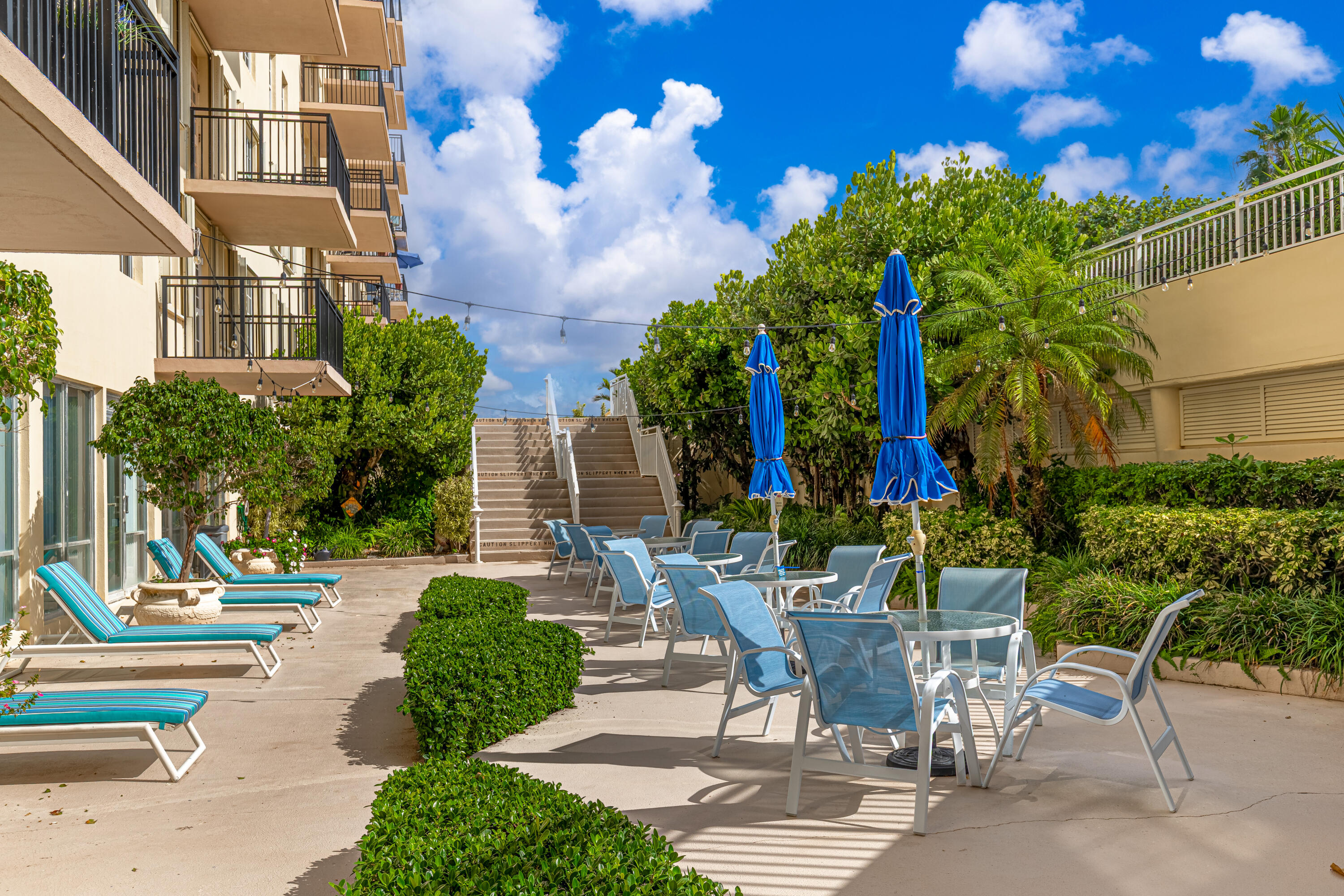 3475 South Ocean Boulevard, Unit 201 Palm Beach, FL 33480 - Photo 24 of 28 a view of a patio with table and chairs and potted plants