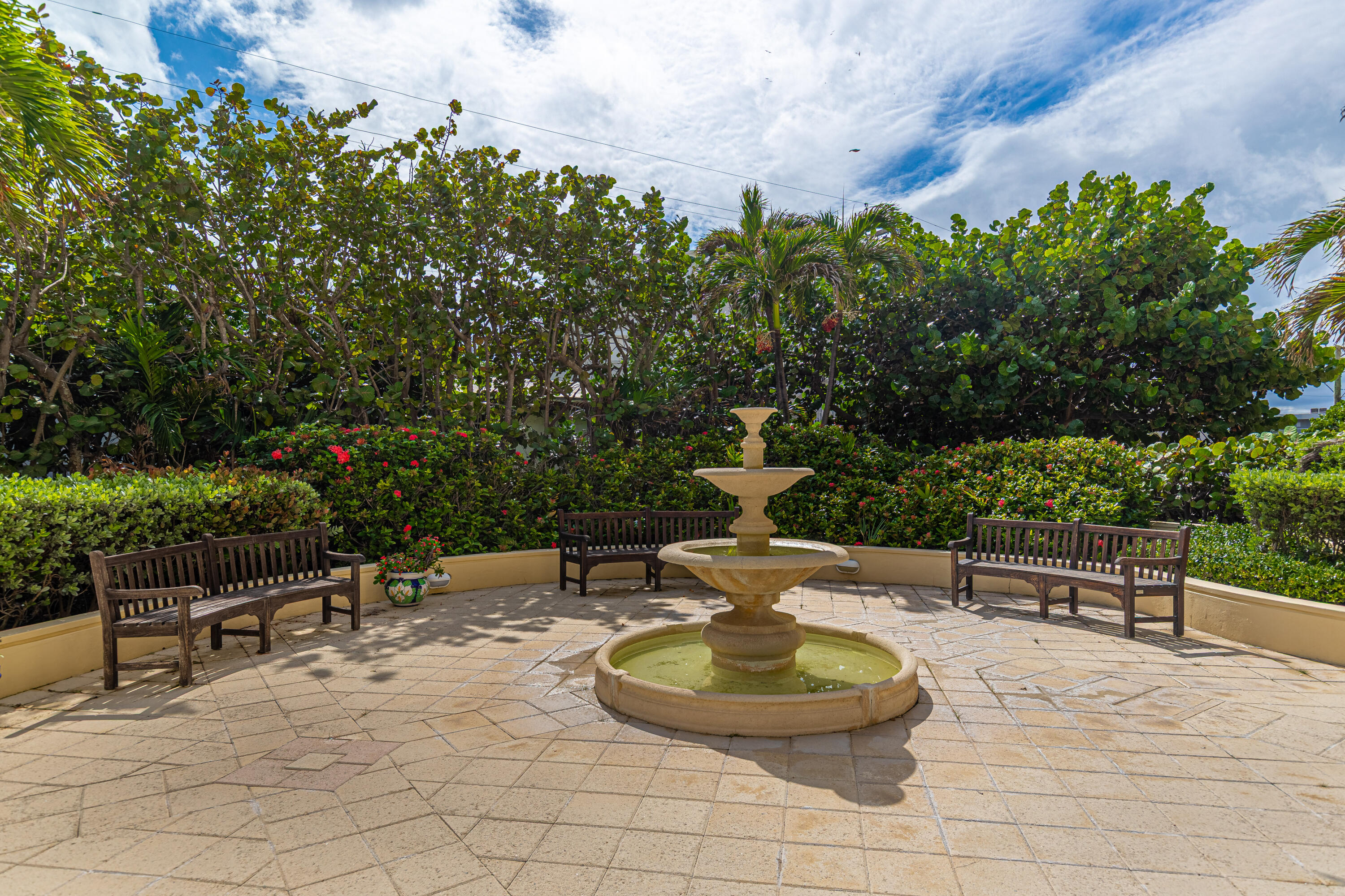 3475 South Ocean Boulevard, Unit 201 Palm Beach, FL 33480 - Photo 27 of 28 a patio with a table and chairs and potted plants