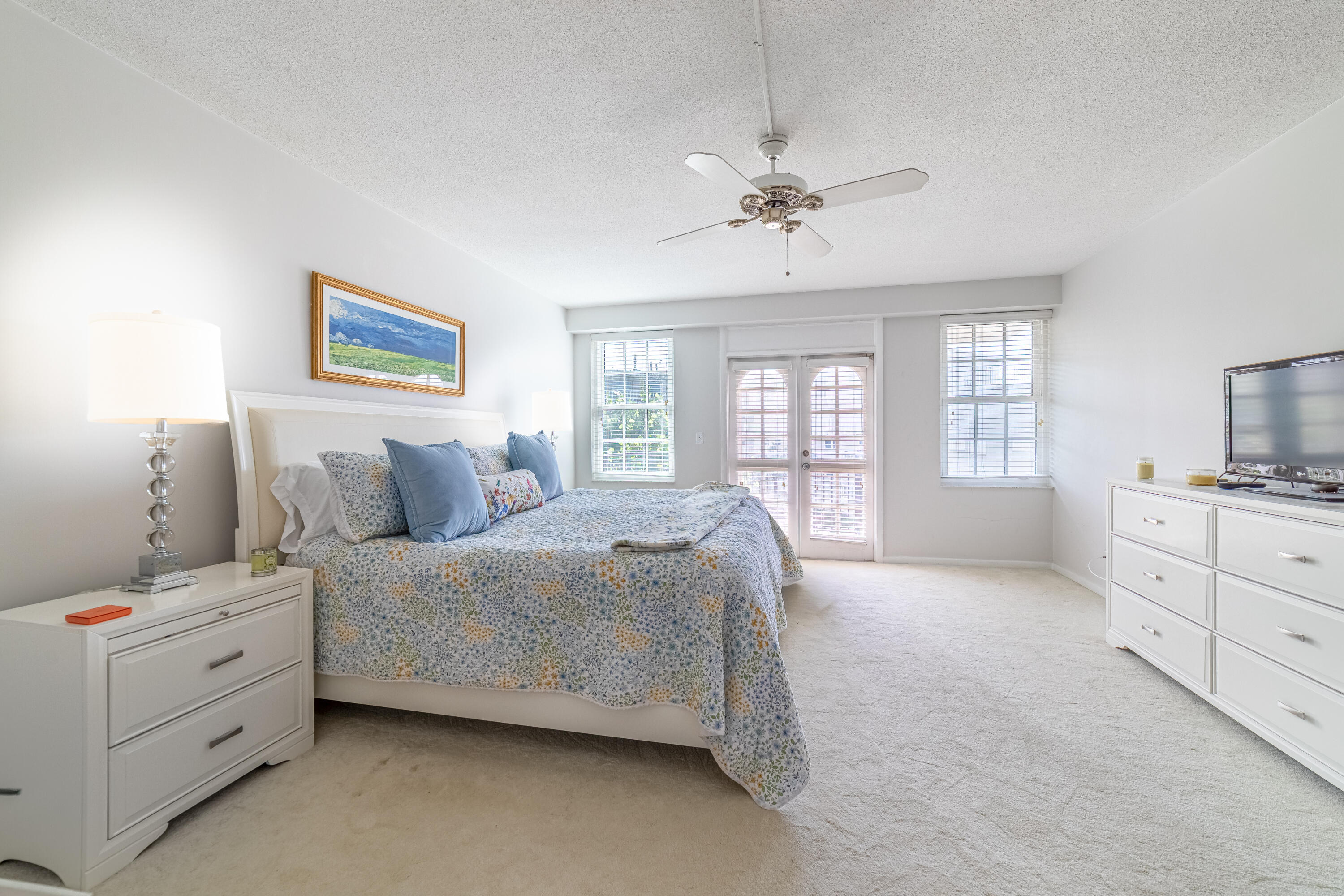 3475 South Ocean Boulevard, Unit 201 Palm Beach, FL 33480 - Photo 9 of 28 a spacious bedroom with a bed and a dresser