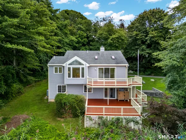 a aerial view of a house with a yard and potted plants
