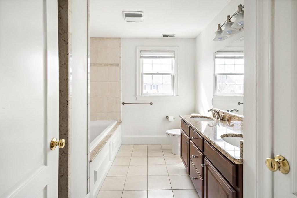 4 Colonial Drive Arlington, MA 02474 - Photo 11 of 19 a bathroom with a tub sink and mirror
