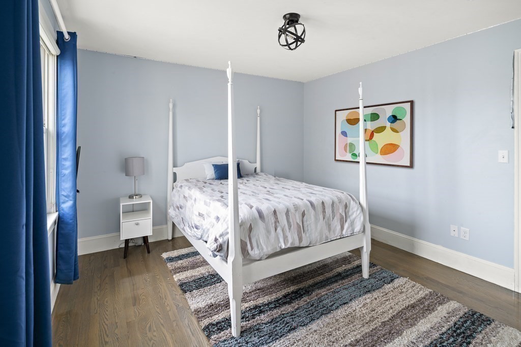 4 Colonial Drive Arlington, MA 02474 - Photo 12 of 19 a bedroom with a bed and a painting on the wall