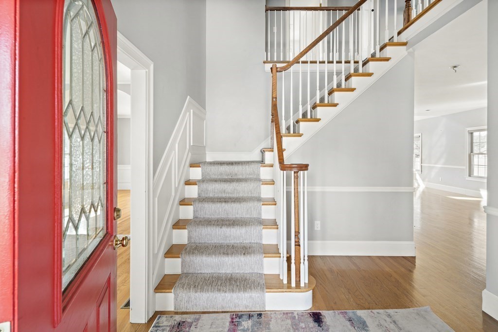 4 Colonial Drive Arlington, MA 02474 - Photo 2 of 19 a view of staircase with wooden floor and a large window