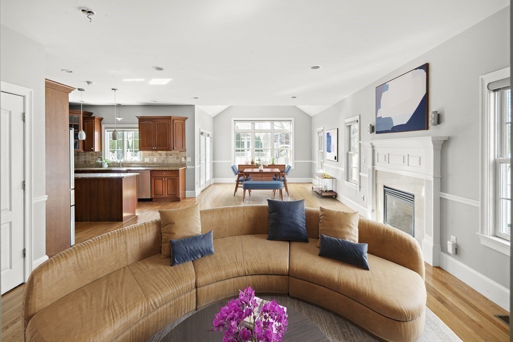 4 Colonial Drive Arlington, MA 02474 - Photo 8 of 19 a living room with furniture kitchen view and a fireplace
