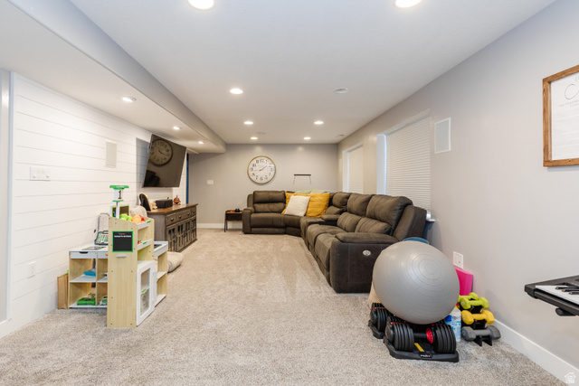 972 West 2840th Street South Logan, UT 84321 - Photo 20 of 46 Spacious room featuring light gray carpet flooring, recessed lighting, white shiplap accent wall, and neutral painted walls