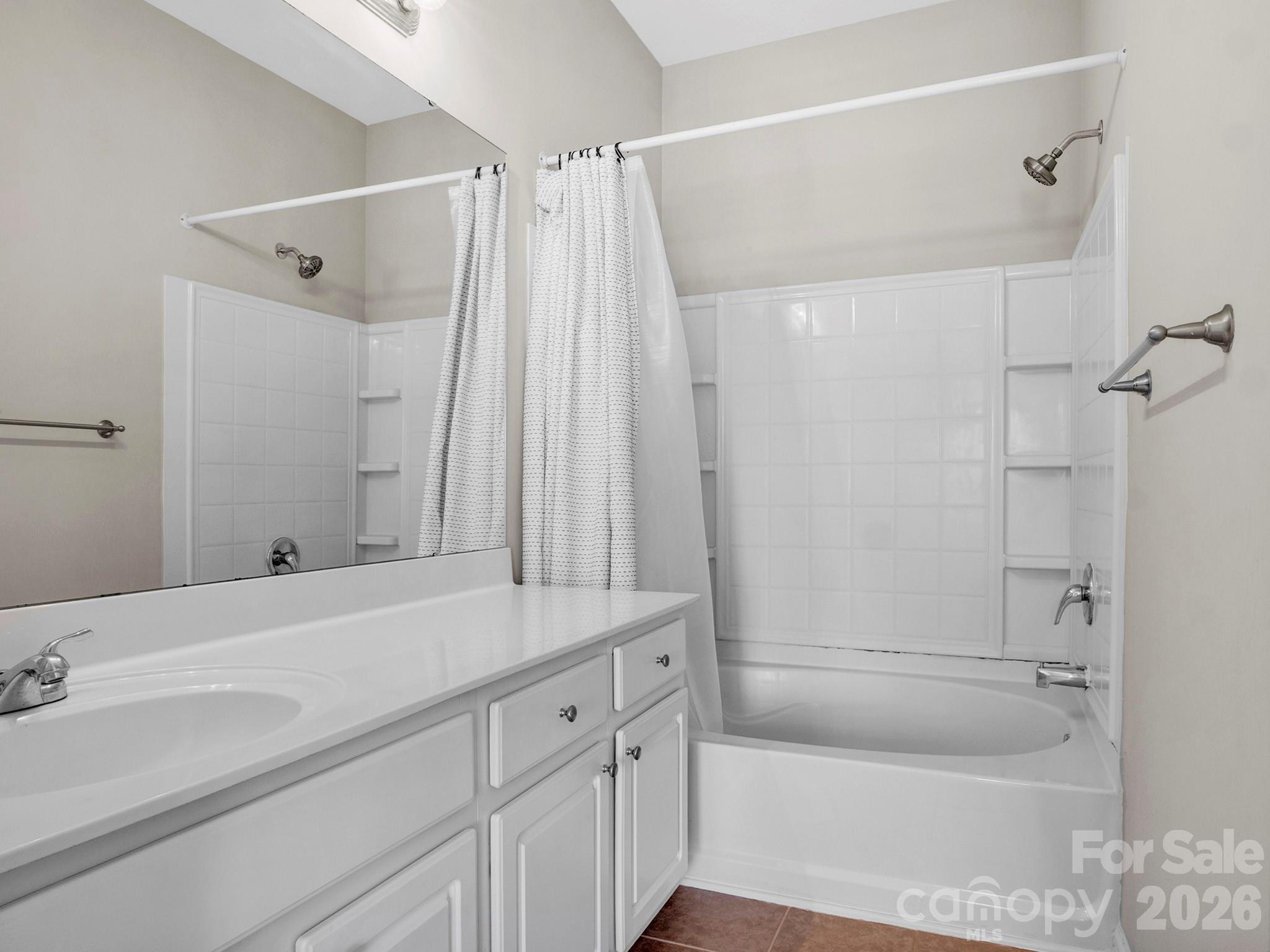 140 Singleton Road Mooresville, NC 28117 - Photo 11 of 17 a bathroom with a granite countertop sink a mirror a vanity and a bathtub
