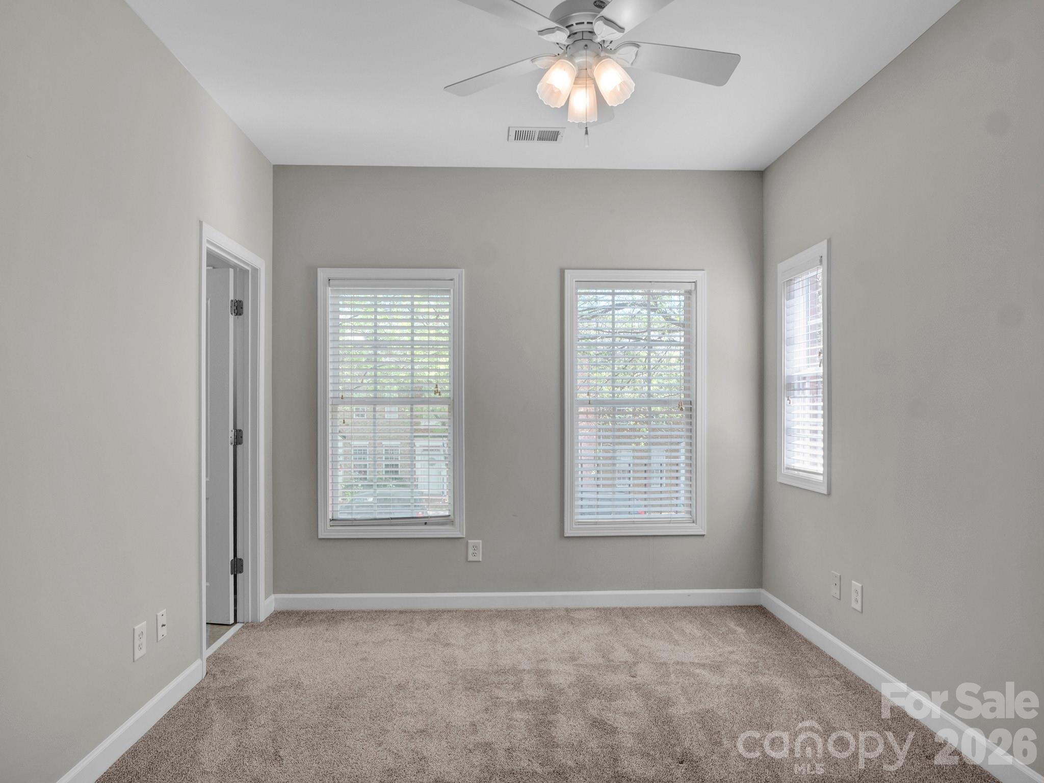 140 Singleton Road Mooresville, NC 28117 - Photo 13 of 17 an empty room with windows and fan