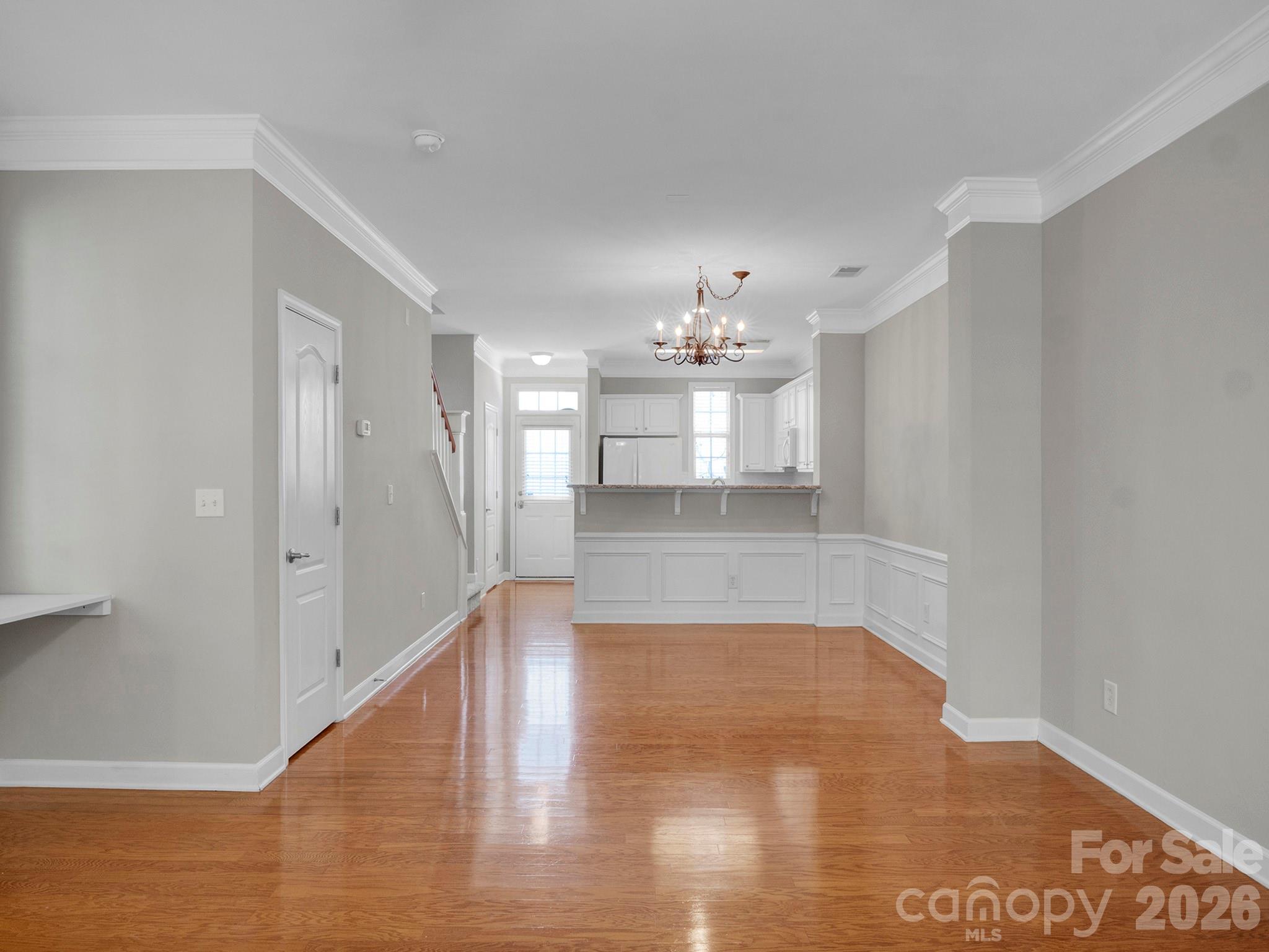 140 Singleton Road Mooresville, NC 28117 - Photo 2 of 17 a view of a hallway with wooden floor and chandelier
