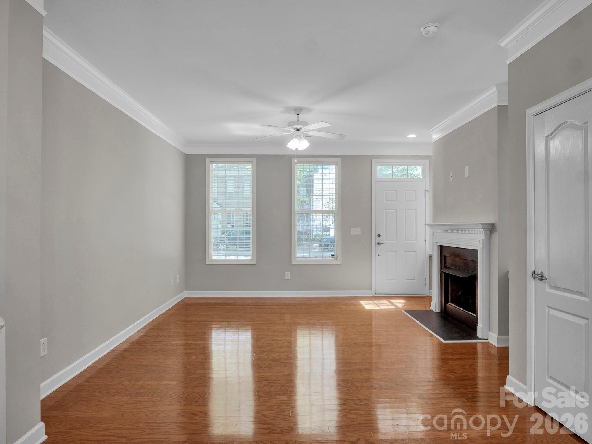 140 Singleton Road Mooresville, NC 28117 - Photo 5 of 17 a view of livingroom with hardwood floor and a ceiling fan