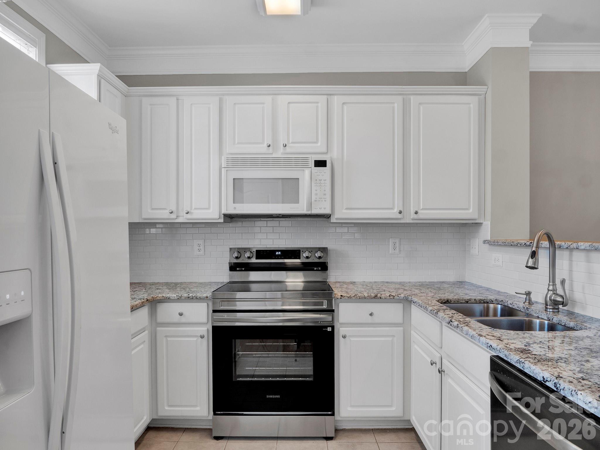 140 Singleton Road Mooresville, NC 28117 - Photo 6 of 17 a kitchen with stainless steel appliances granite countertop white cabinets and a stove top oven