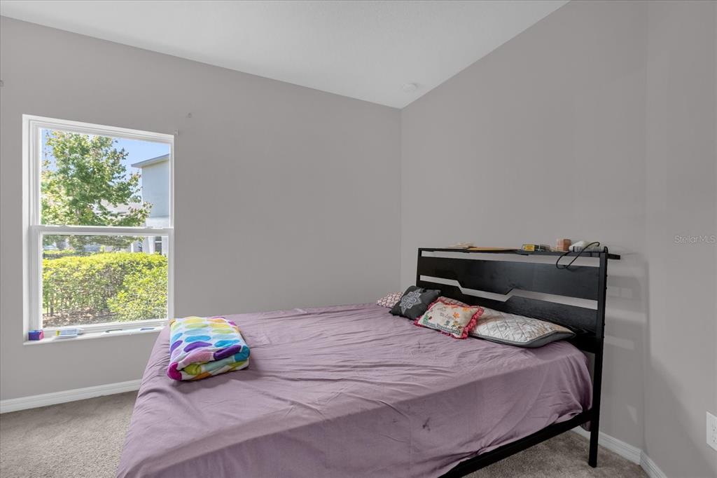 3470 Beau Road Kissimmee, FL 34746 - Photo 23 of 40 a bedroom with a bed and window