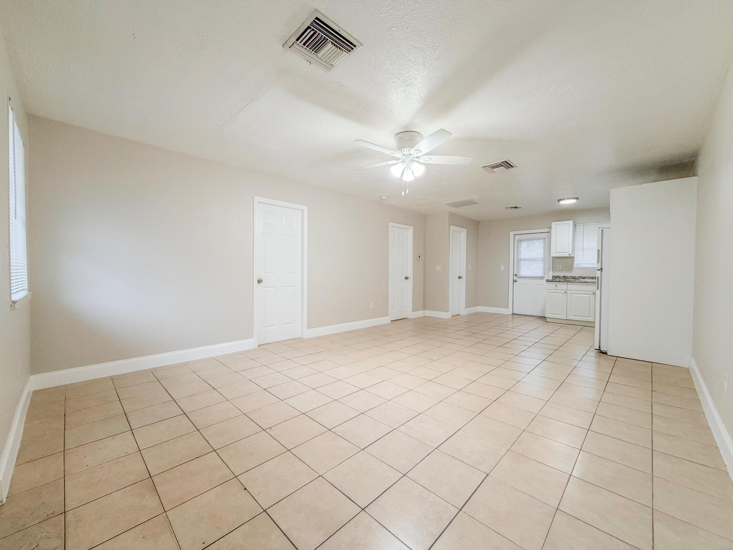 a view of an empty room and a window