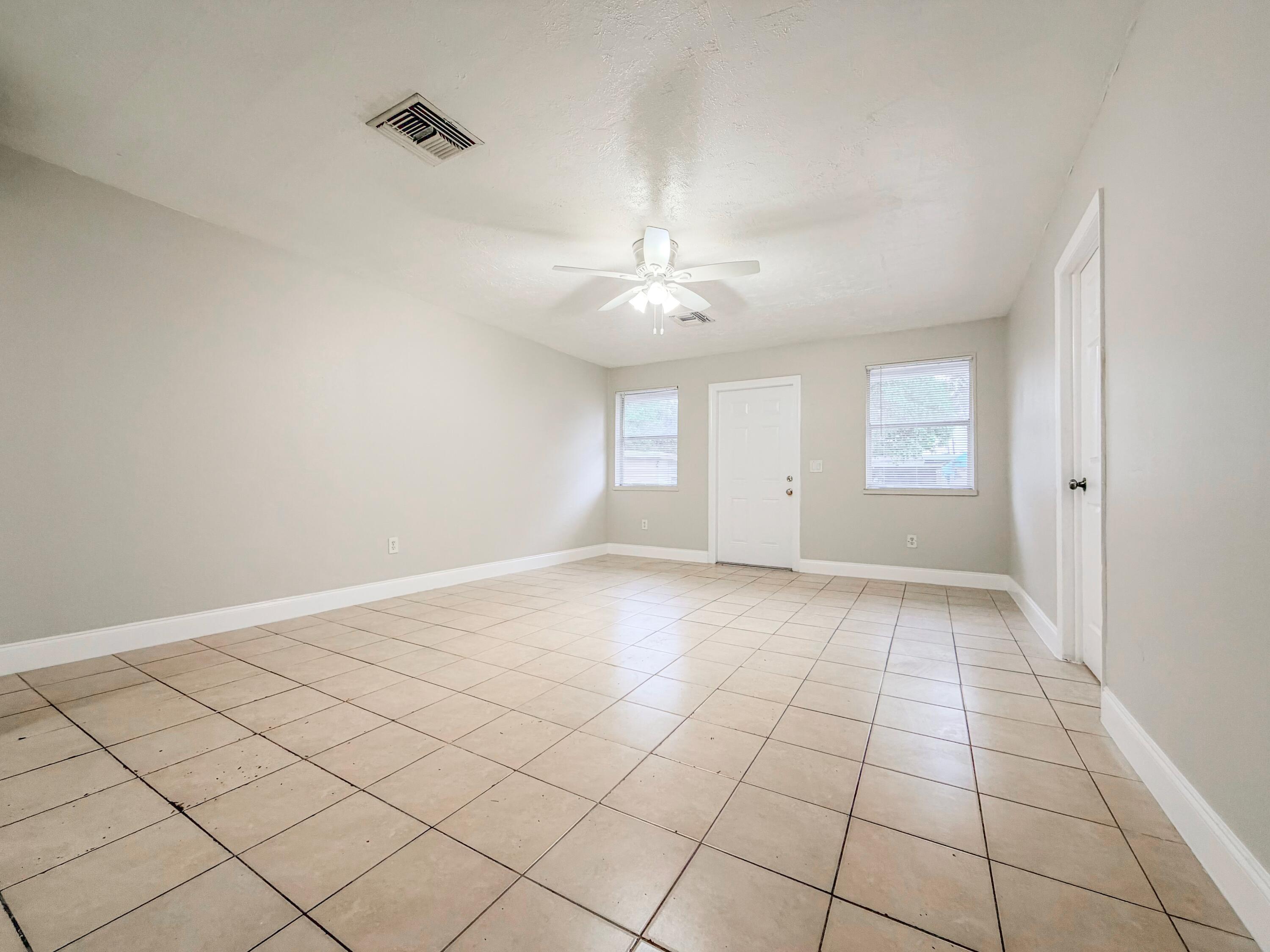 3077 Floweva Street Palm Springs, FL 33406 - Photo 4 of 12 a view of an empty room with a window