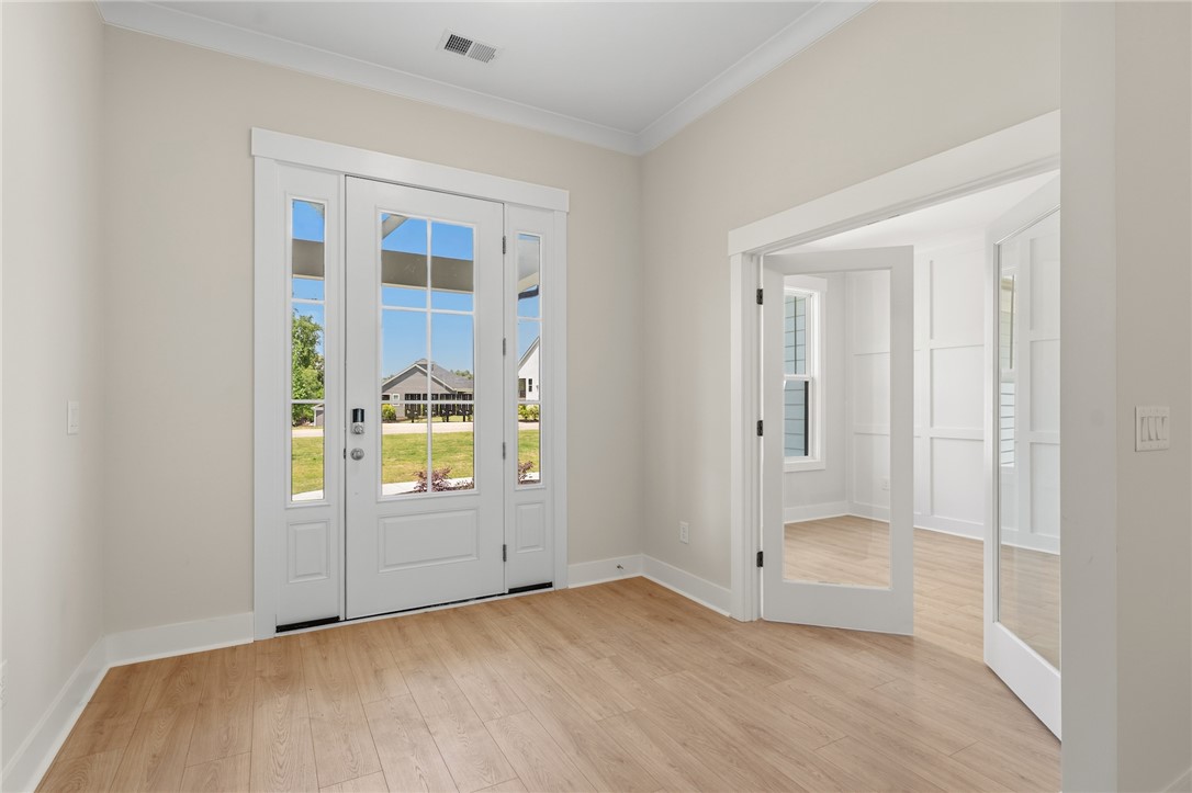 203 Timothy Court Anderson, SC 29621 - Photo 26 of 40 Natural light streams through the elegant French doors, illuminating the inviting hardwood flooring.