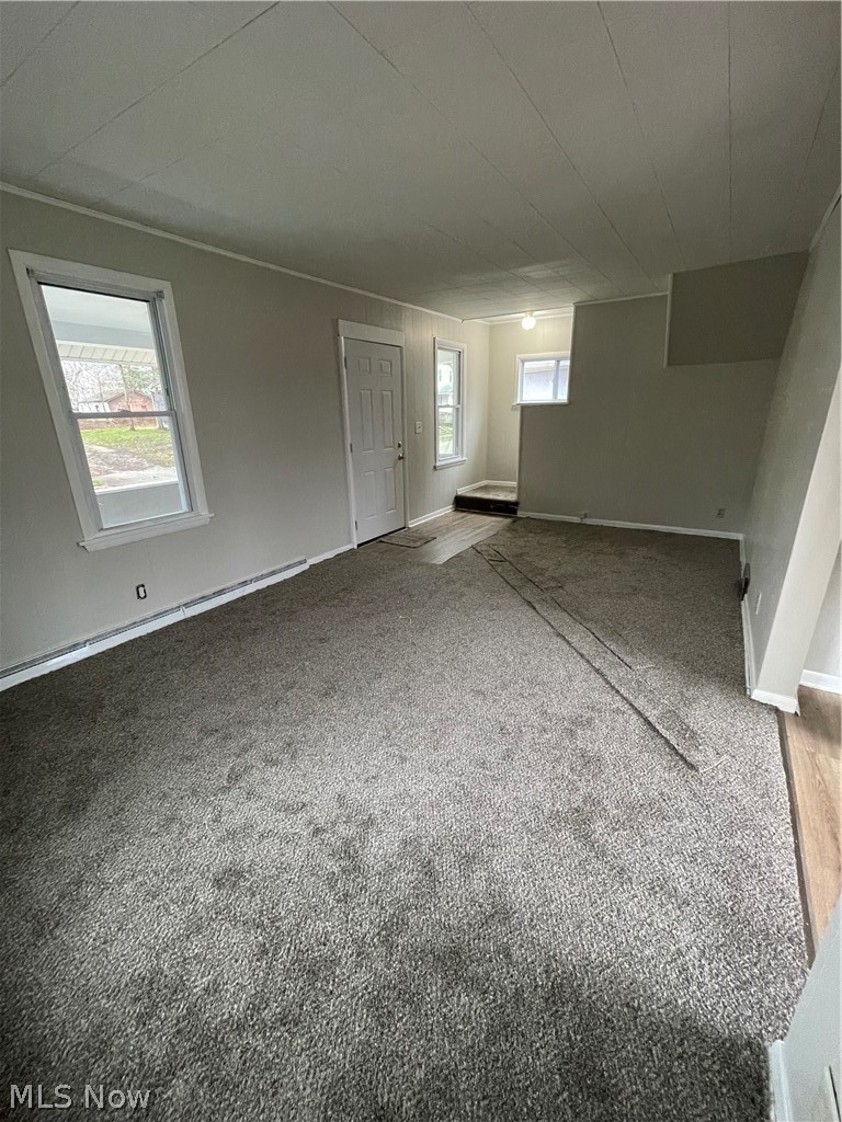933 Inman Street Akron, OH 44306 - Photo 3 of 25 Carpeted empty room featuring a baseboard heating unit
