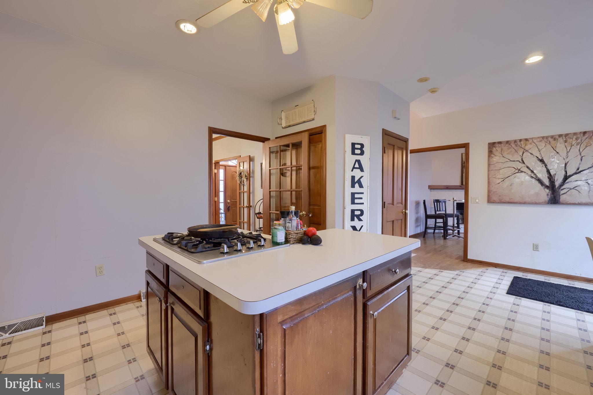180 Springvale Road Red Lion, PA 17356 - Photo 15 of 70 a kitchen that has a sink a stove and a table with wooden floor
