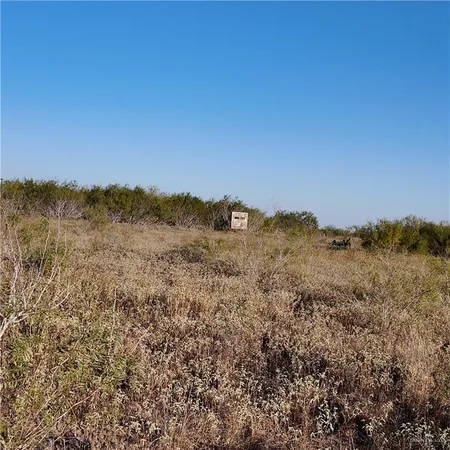 a view of a large building with mountains in the background
