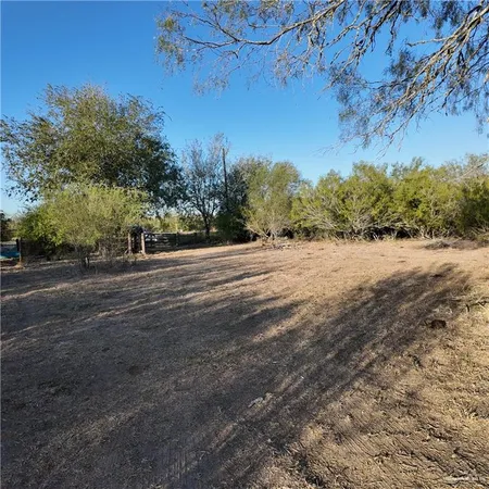 a view of dirt road with a building in the background
