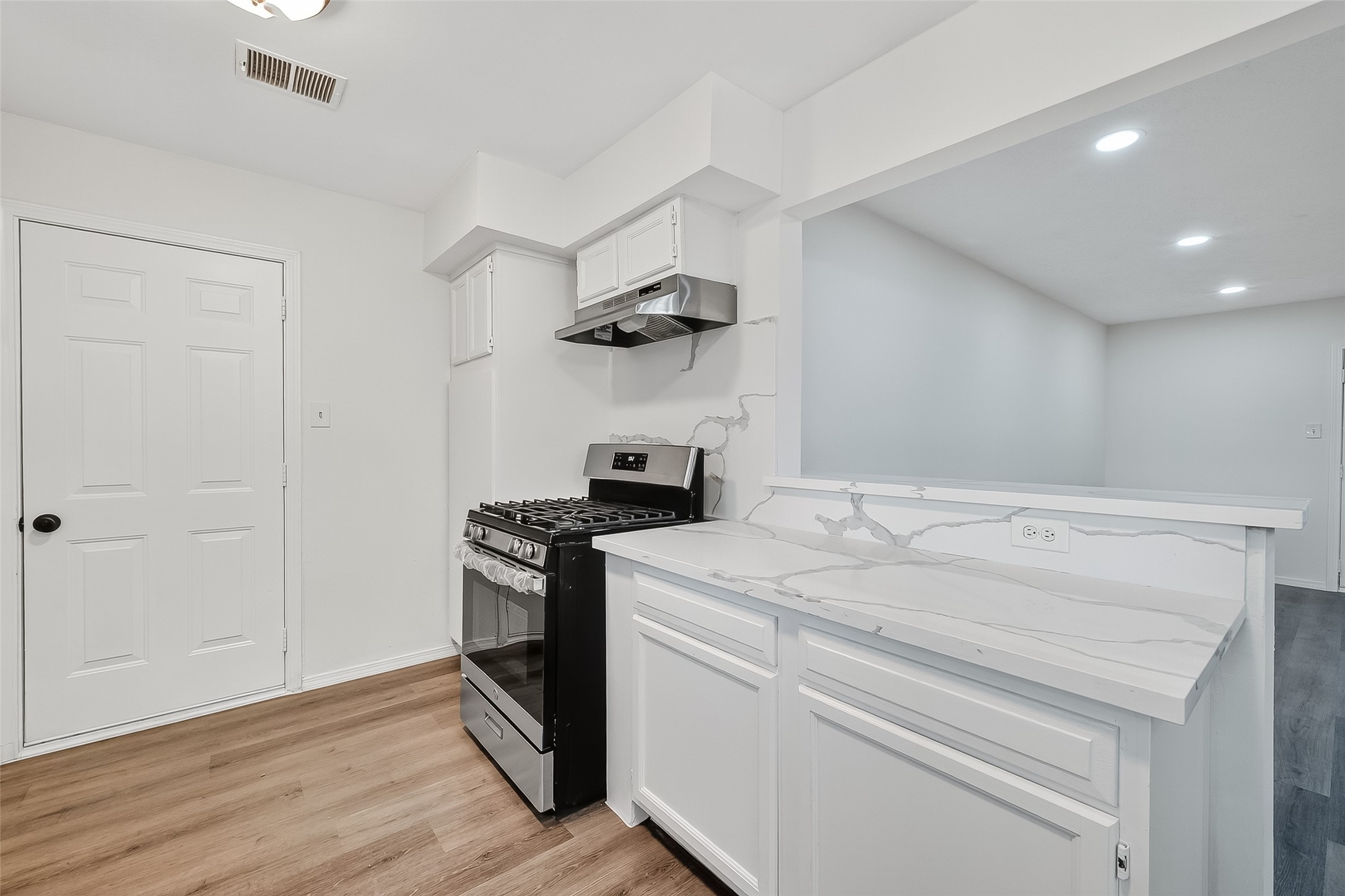 26522 Hillside Drive Spring, TX 77386 - Photo 16 of 45 a kitchen with a stove and a wooden floor