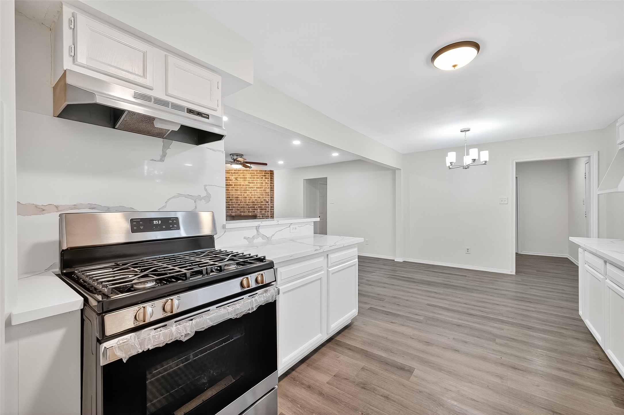 26522 Hillside Drive Spring, TX 77386 - Photo 17 of 45 a kitchen with stainless steel appliances granite countertop a stove and a wooden floors
