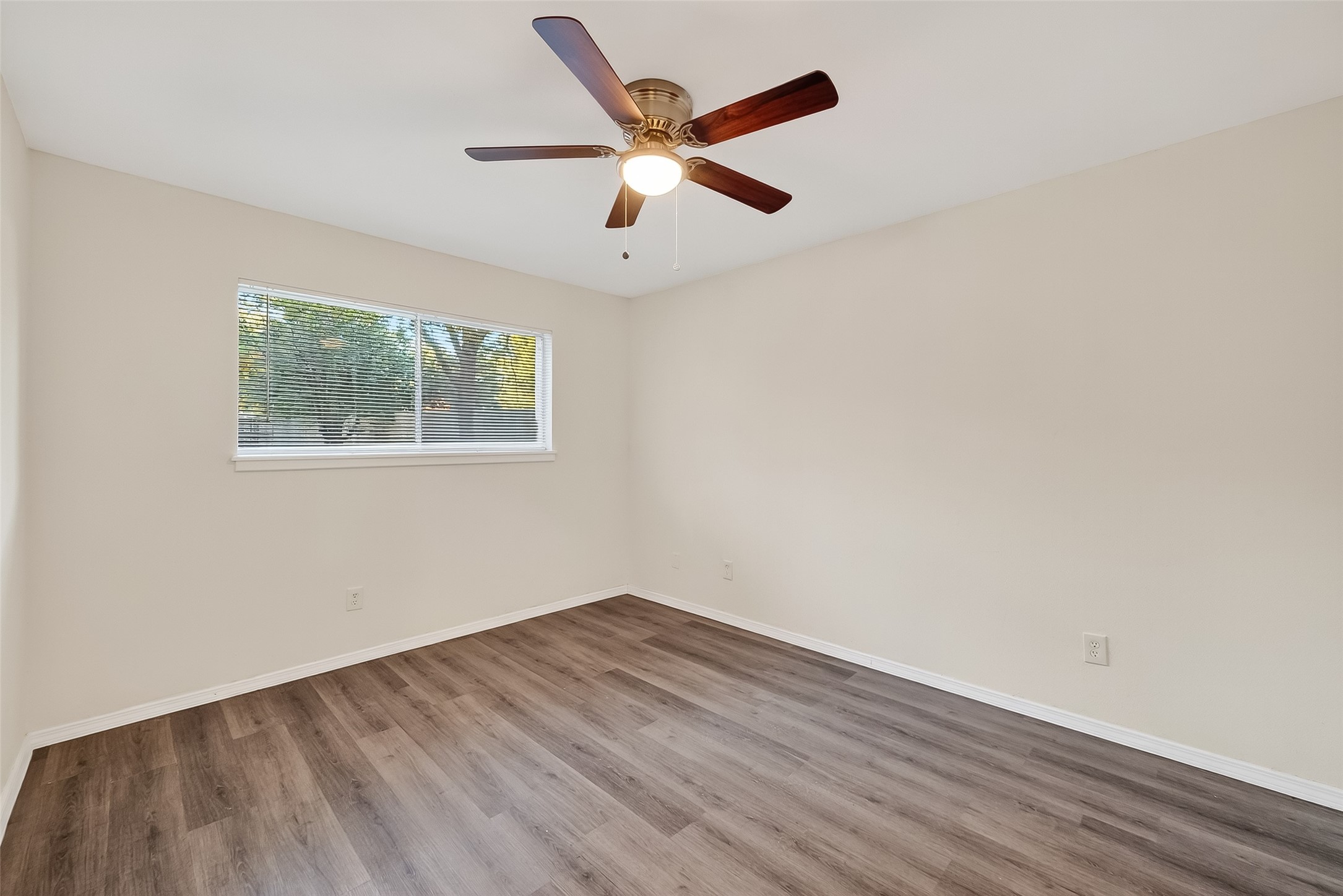 26522 Hillside Drive Spring, TX 77386 - Photo 20 of 45 an empty room with wooden floor and ceiling fan