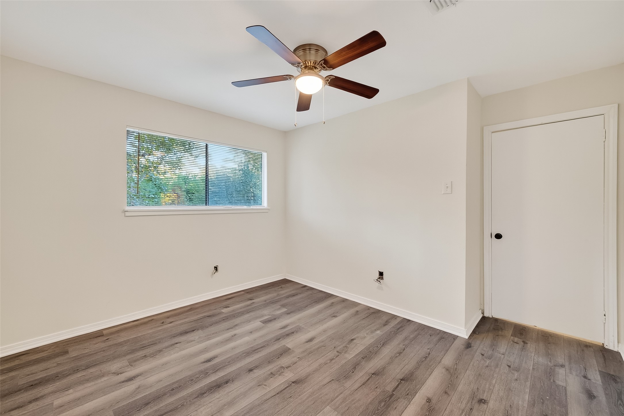 26522 Hillside Drive Spring, TX 77386 - Photo 25 of 45 an empty room with wooden floor and ceiling fan