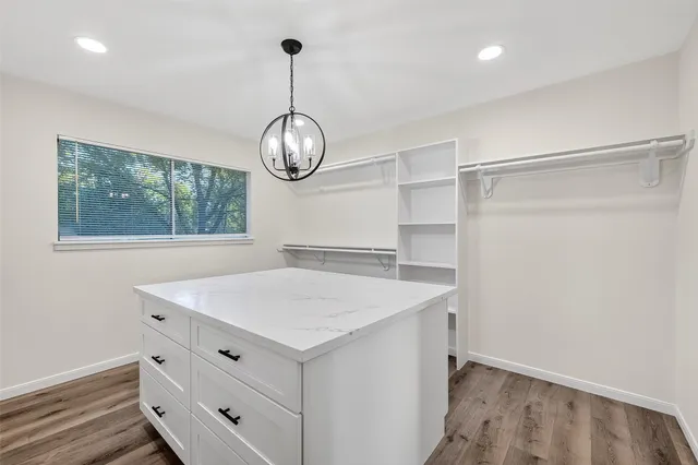 a view of a room with cabinets and wooden floor