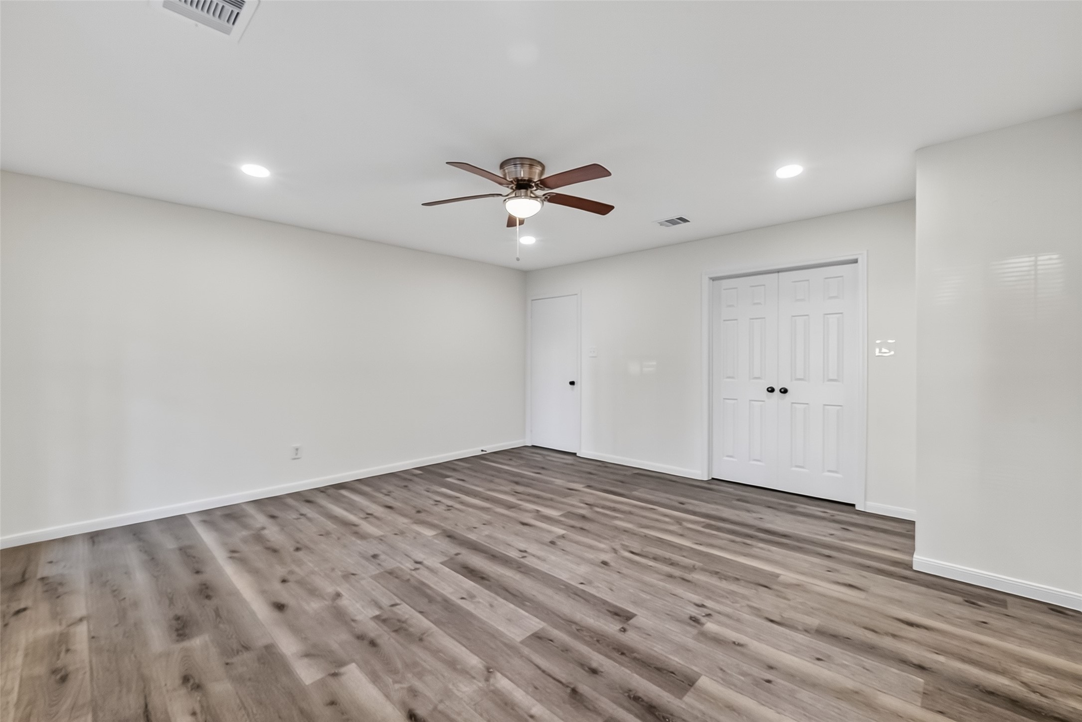 26522 Hillside Drive Spring, TX 77386 - Photo 41 of 45 wooden floor in an empty room with a ceiling fan