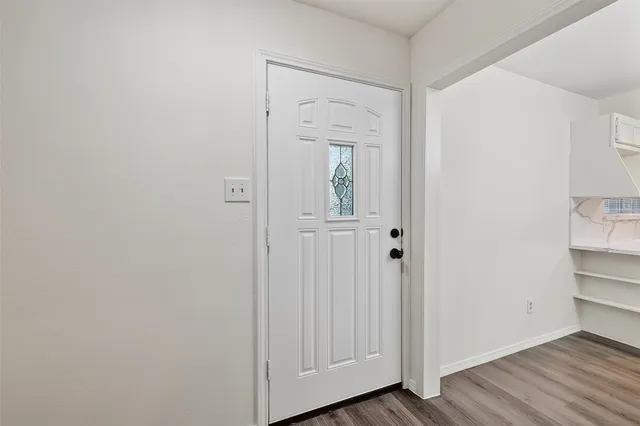a view of a closet area with wooden floor