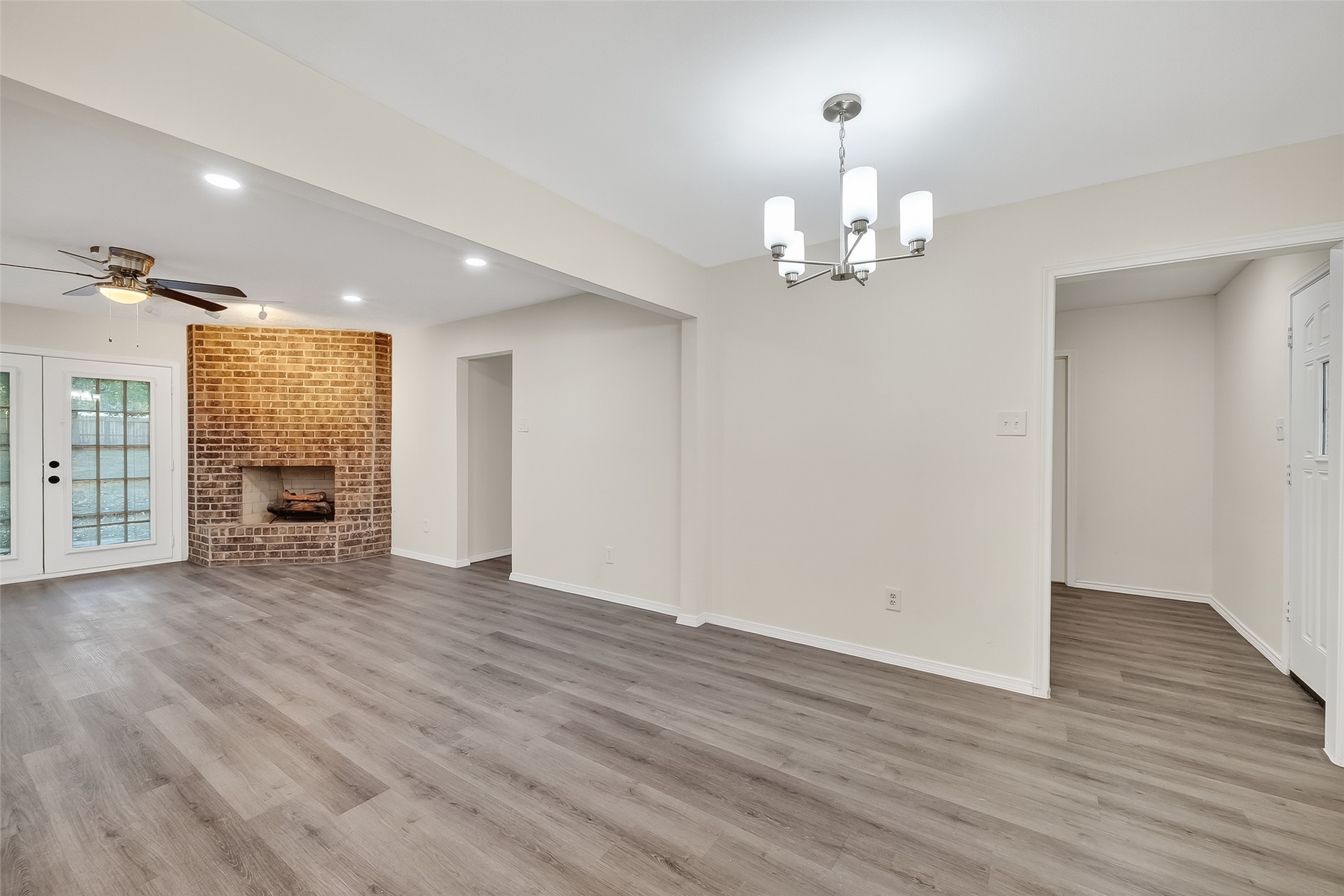 26522 Hillside Drive Spring, TX 77386 - Photo 7 of 45 an empty room with wooden floor chandelier and windows