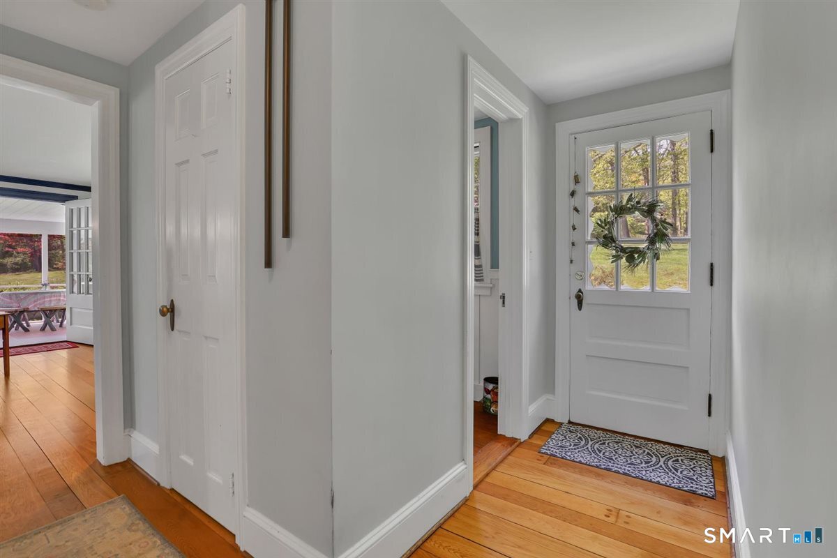 292 Parmelee Hill Road Durham, CT 06422 - Photo 23 of 39 Rear hallway showing door to backyard, powder room, living room, and closet.