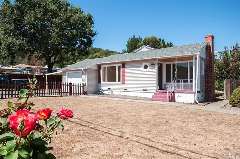 667 Canyon Road Novato, CA 94947 - Photo 1 of 1 a front view of a house with a yard and a garage