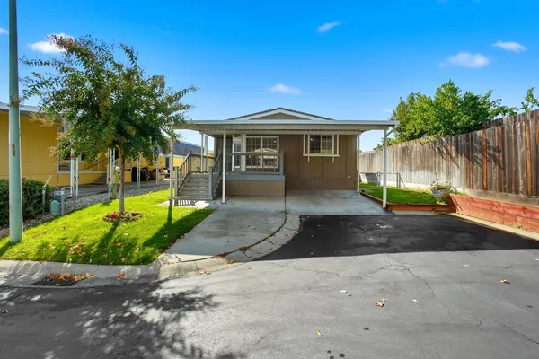 a view of a house with backyard and tree s