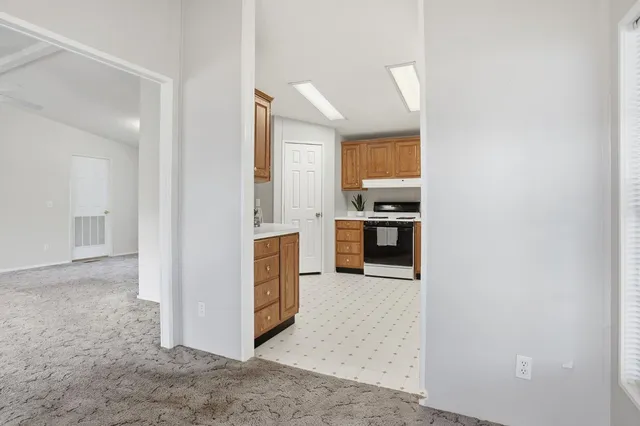 a view of a kitchen with a sink and a refrigerator