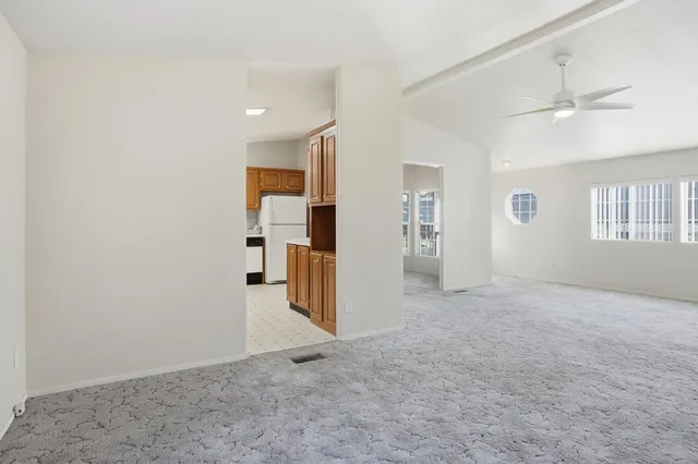 an empty room with closet and windows