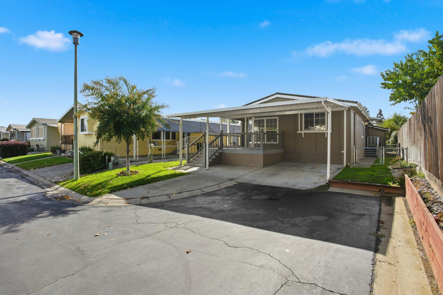 700 2nd Street, Unit 40 Galt, CA 95632 - Photo 2 of 35 a front view of a house with a yard and potted plants