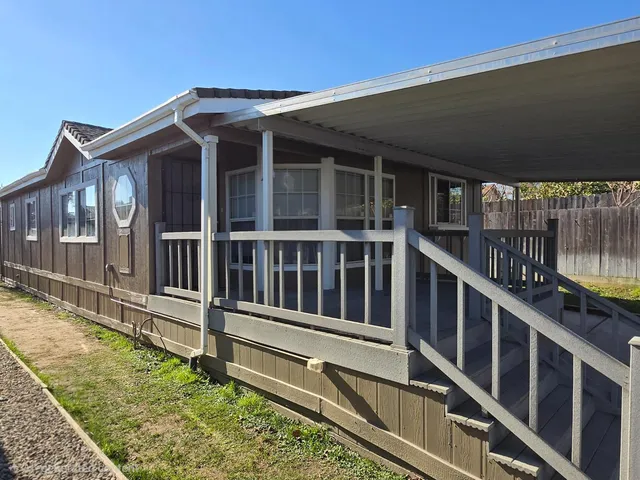a view of wooden house with a large window