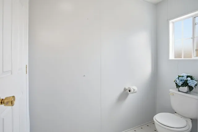 a white toilet sitting next to a bathroom sink