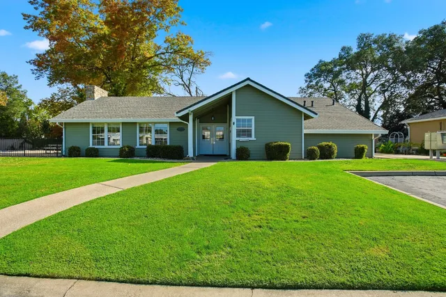 a front view of house with yard and green space