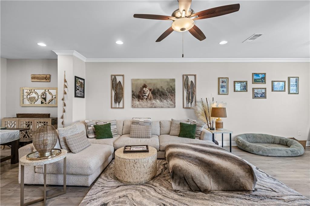 3766 Alstead Manor Way Suwanee, GA 30024 - Photo 11 of 41 a living room with furniture and a ceiling fan