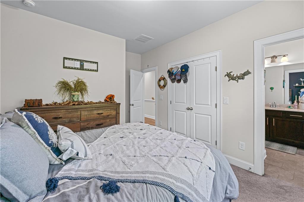 3766 Alstead Manor Way Suwanee, GA 30024 - Photo 23 of 41 a bedroom with a bed and cabinet